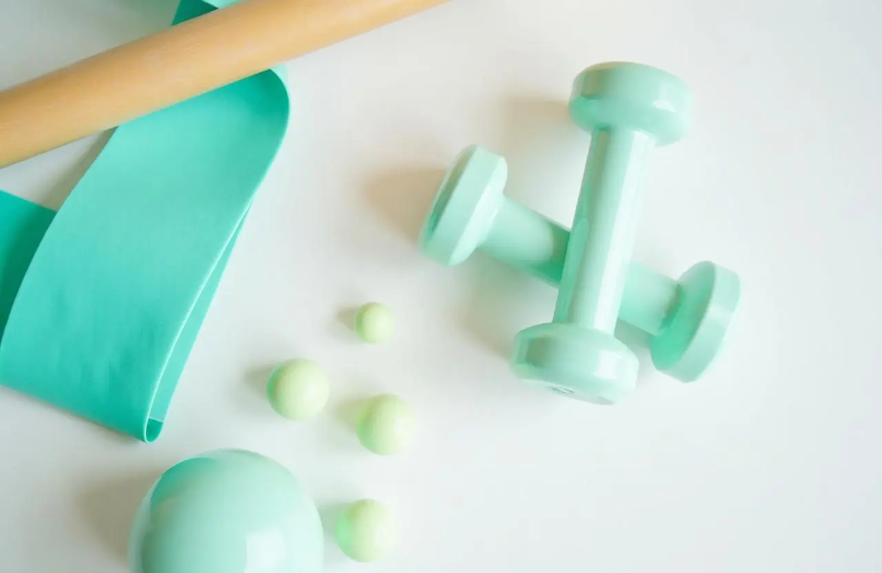 Banda elástica turquesa, mancuernas y pelotas terapéuticas para fisioterapia neurológica